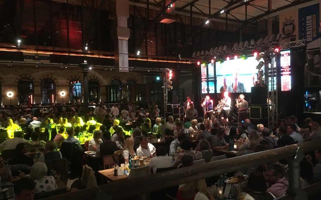 Gäste tanzen und genießen die Livemusik bei der Silvesterparty in der Kälberhalle