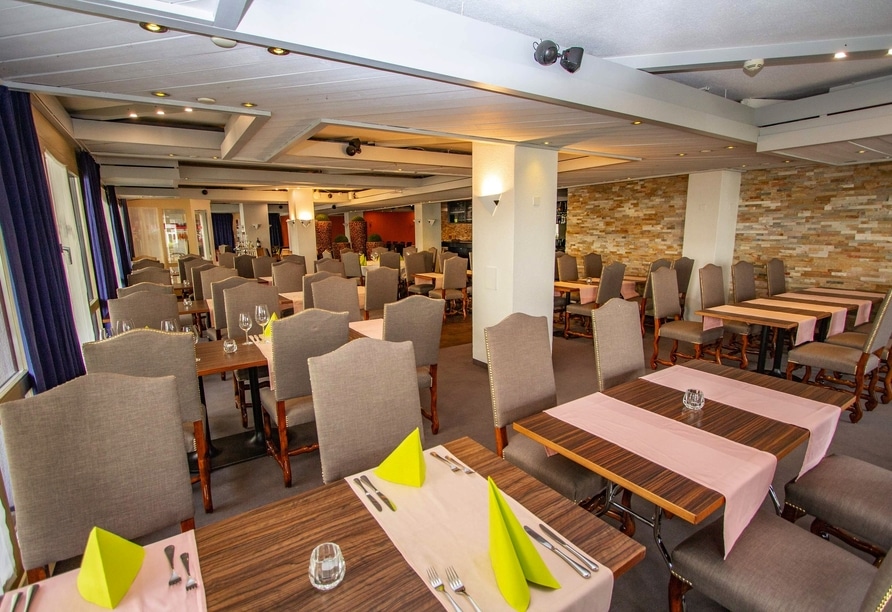 Modern eingerichtetes Restaurant im City Hotel Brunnen mit gedeckten Tischen für das Silvester-Dinner